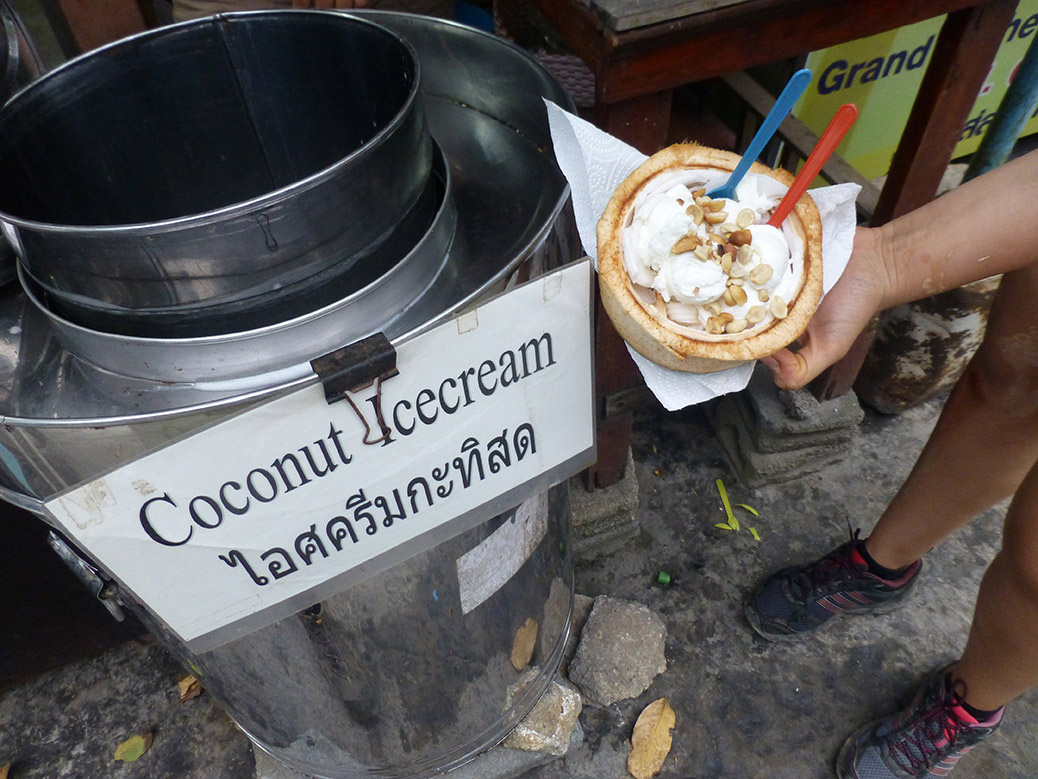 Eating coconut ice cream made from actual coconut served in a coconut shell near Hin Ta on Lamai Beach