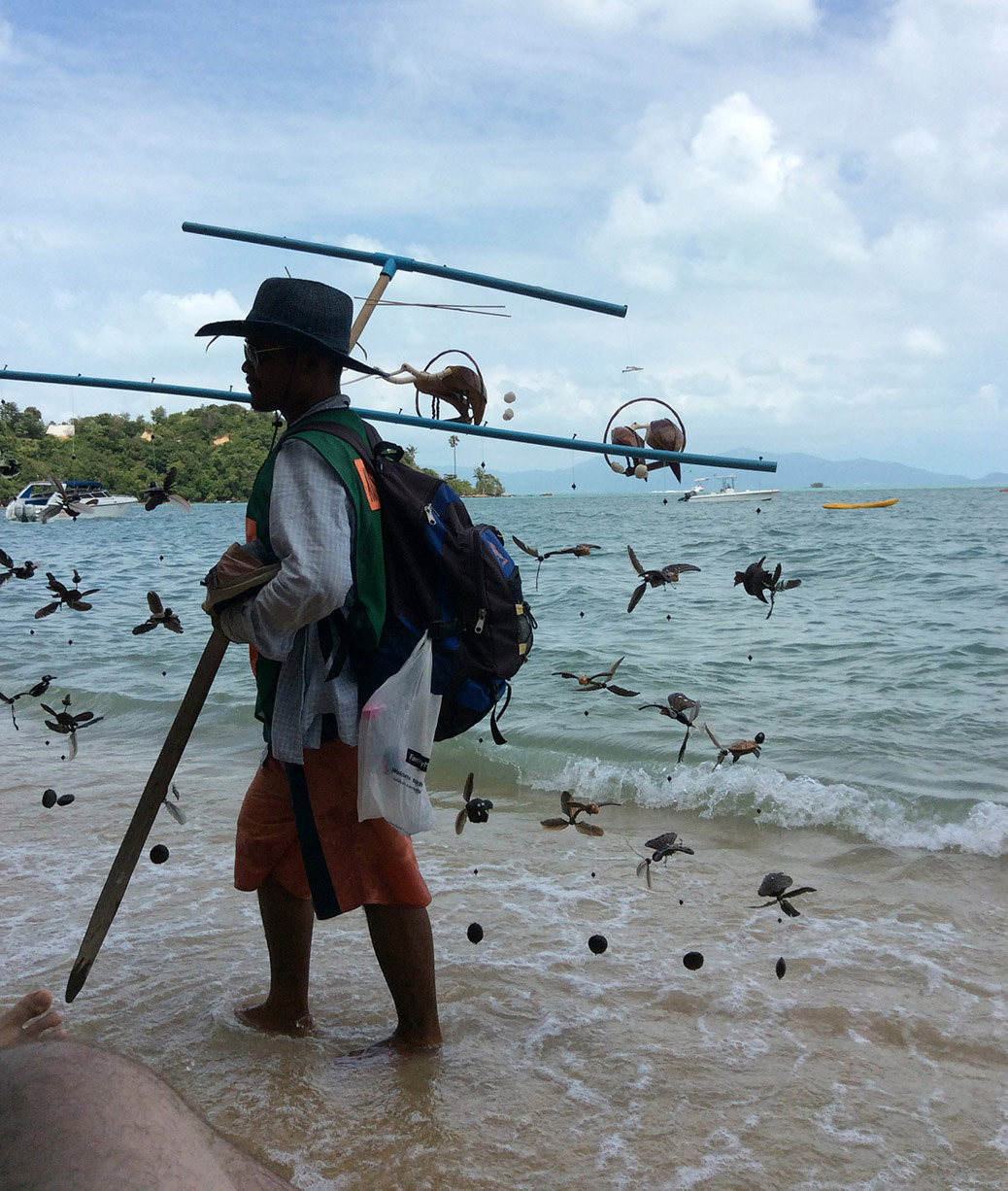 A beach vendor selling bird wind chimes in Bo Phut