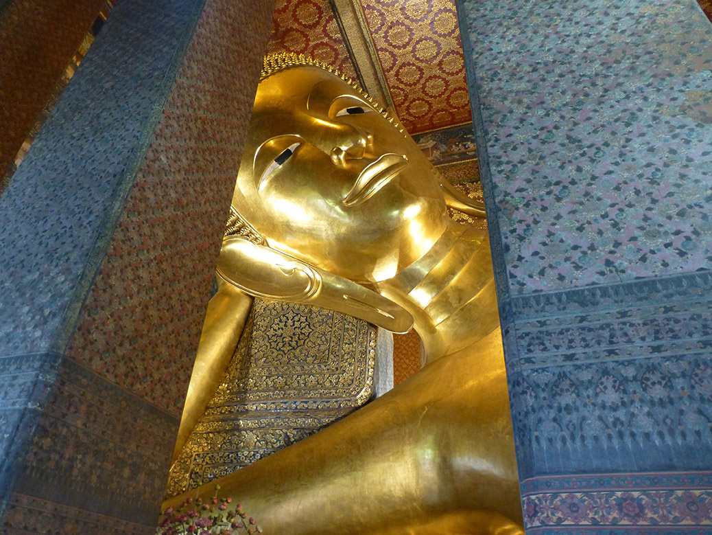 At Wat Pho, we visited the giant reclining Buddha. It's 50 feet tall and 150 feet long. 