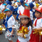 Adorable boys and girls marching in the parade