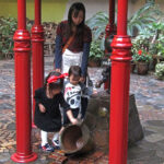 A little girl dressed as Kiki from the Miyazaki film Kiki's Delivery Service at the Studio Ghibli Museum