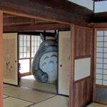 Totora peeking out of the back room of the Kurosuke House