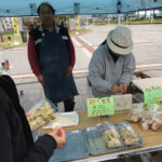 Sampling deep-fried shitake at Hiroshima Minato Marché