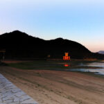 The morning sun casts a glow on the Great Torii