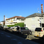 The chimneys of three of Saijo's sake breweries rise above the modern apartments. Only Saijotsuru still uses its chimney in production, but the preserved steam stacks are part of the attraction today.