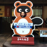 Character cutouts line the streets of Miyajima's shopping streets. In this one, my head is a nose.