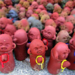 Small clay Buddha statues are left as offerings at the Mt. Misen Observatory