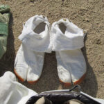 A pair of shoes belonging to one of the monks who run barefoot through blazing fire and over hot coals