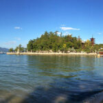 A panorama of Miyajima's World Heritage properties. Left to right: The Great Torii; Toyokuni Shrine and its five-storied pagoda; and Itsukushima Shrine