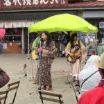 A local band performing for the rain-soaked crowd