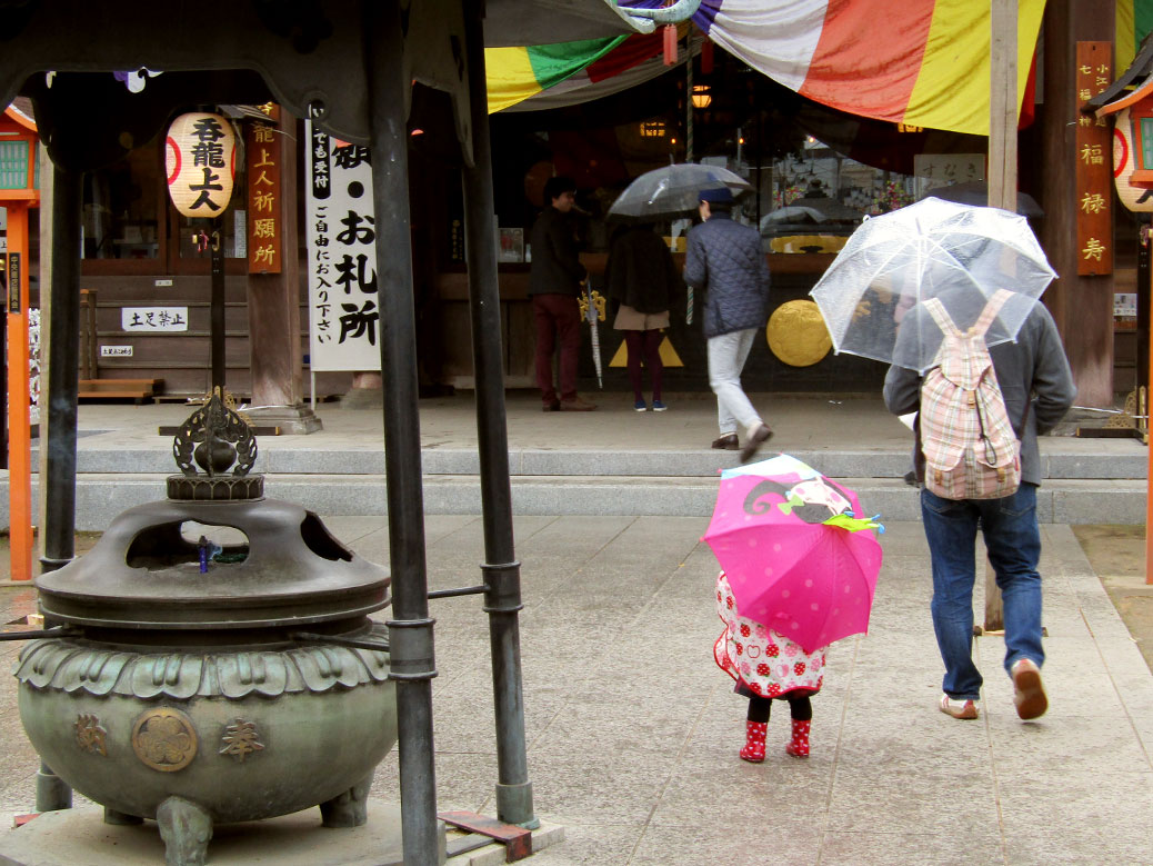 A young girl braving the rain at the Kawagoe Farmers Market at Renkeiji Temple