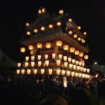 The massive yatai (ornate float) is pushed and pulled through the Nakamachi district