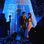 A couple poses for wedding photos at Caretta Shiodome's Canyon d'Azur light display