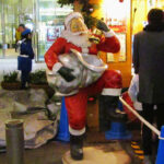 This statue of Santa was probably missing a chimney for his foot to rest on. The bell looked more like a bottle of liquor, so maybe Santa was just striking a Captain Morgan pose?