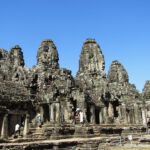 Bayon temple stands at the exact center of the ancient capital of Angkor Thom. Around 200 faces of Lokesvara, the bodhisattva of compassion, are carved on Bayon's towers, giving it the nickname of "The Temple of Smiling Gods."