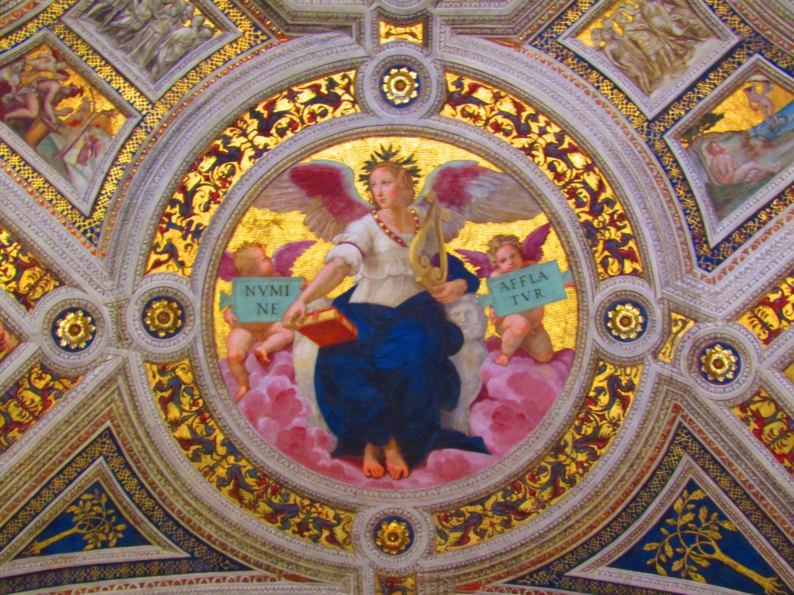 The Vatican is more than the world headquarters for the Catholic Church. It's also home to a world-class collection of art from some of the great masters including Michelangelo, Leonardo da Vinci, Carvaggio and Raphael. Some of the most prolific work belongs to Rafael, including the four rooms of the Papal apartment known as the Stanze di Raffaello or Rafael Rooms. The rooms are covered in extravagant frescos detailing various tales from Christianity. Ceiling medallions such as this one, entitled "Poetry," depict some of the core tenants of the religion. The phrases held by the angels read "Touched by the Breath of God."