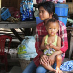 The families who run souvenir stands on the road from Ta Prohm live directly behind their tents. We were fortunate to meet this family very briefly and learn a little about how they live.