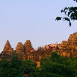 Tourists crowd the platform of Phnom Bakheng to wait for the sunset and a view of Angkor Wat.