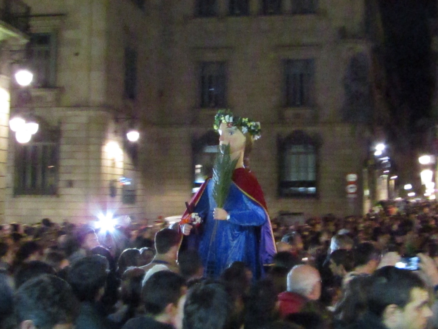 Saint Eulalia, or Laie, wades through the crowds at the end of the procession through the narrow city streets.