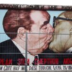 One of the most famous pieces at the East Side Gallery, entitled "My God, Help Me to Survive This Deadly Love" by Dmitri Vrubel recreates a famous photo of Soviet Chairman Leonid Brezhnev and East Germany Chairman Erich Honecker engaging in a kiss.