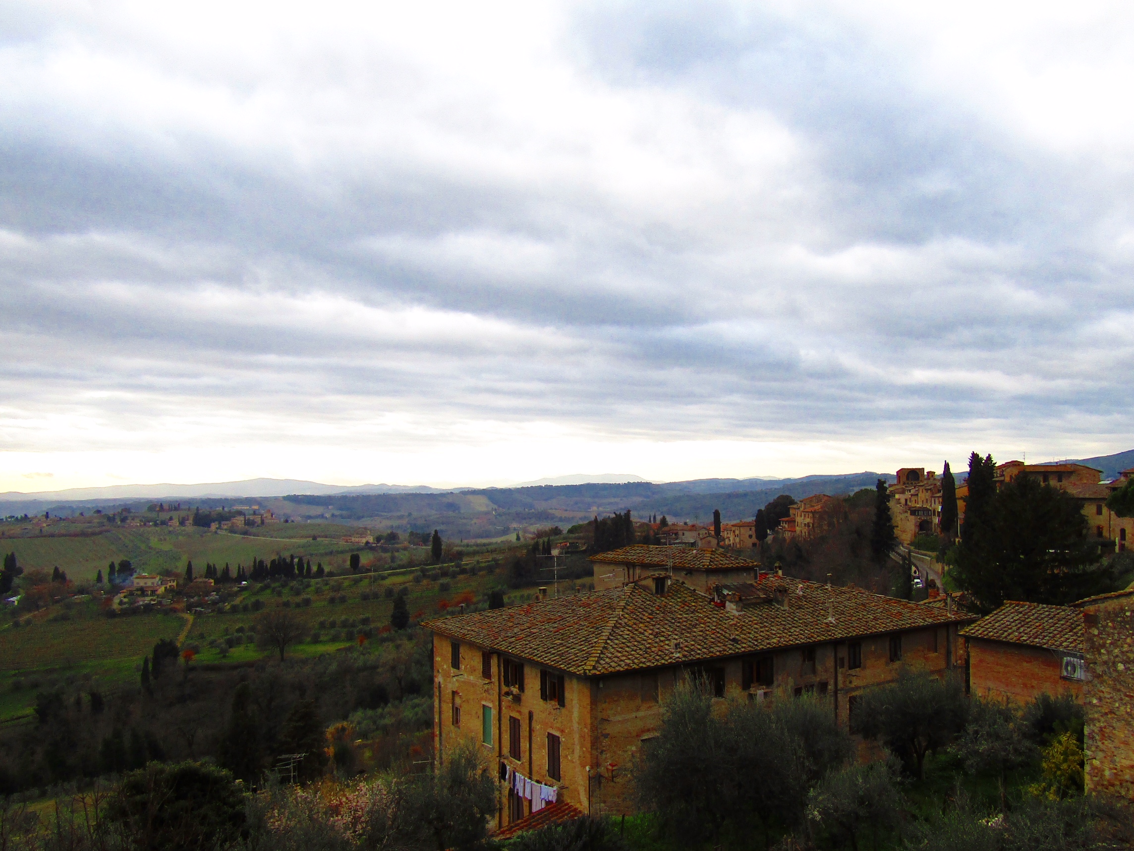 A view of Tuscany's rolling hills over the picturesque homes of San Gimignano.