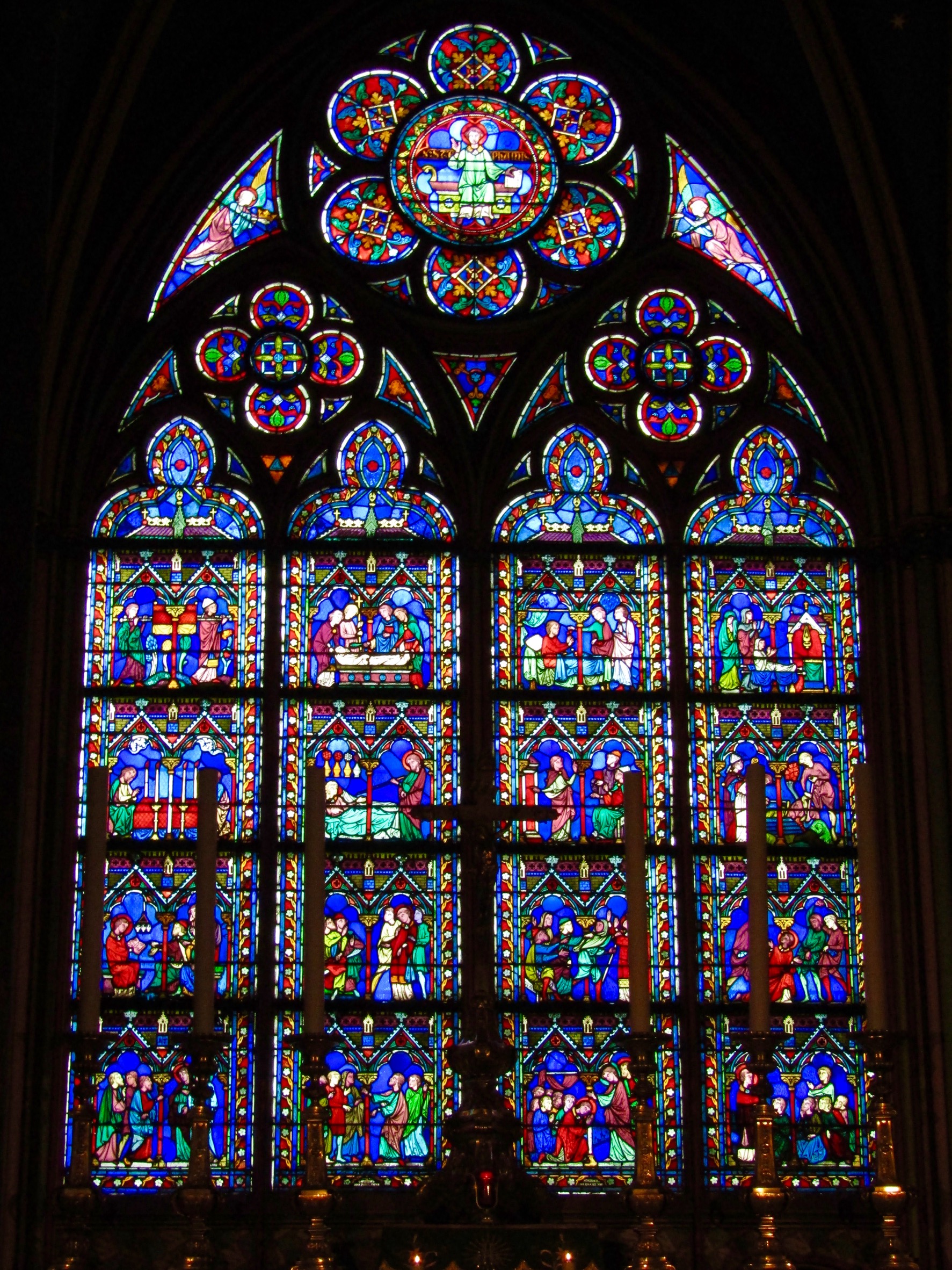 One of the many stained glass windows depicting various biblical scenes inside the cathedral at Notre-Dame.