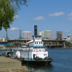 The Sternwheeler Portland docked along the Willamette River at the Oregon Maritime Museum. It is the last operating steam-powered sternwheel tug in the U.S.