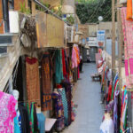 Peering down an alley with tourist shops.