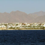 Dusty mountains and blue waters.