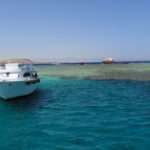 A boat sits waiting for snorkelers and divers to finish exploring.