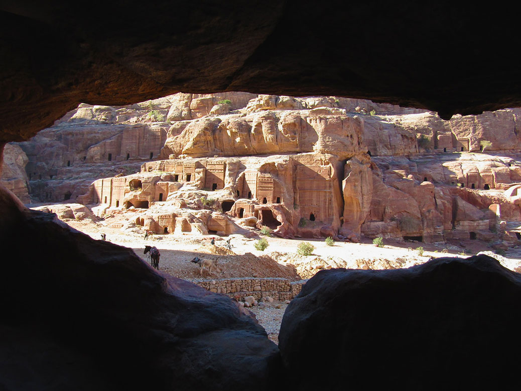 Peeking out of a cave onto a series of tombs of everyday Nabataean people.