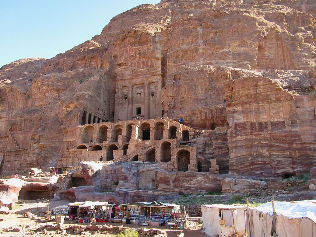 The Urn Tomb at Petra. At the base of the mountain, the B'doul tribe sells wares including stones from temples.